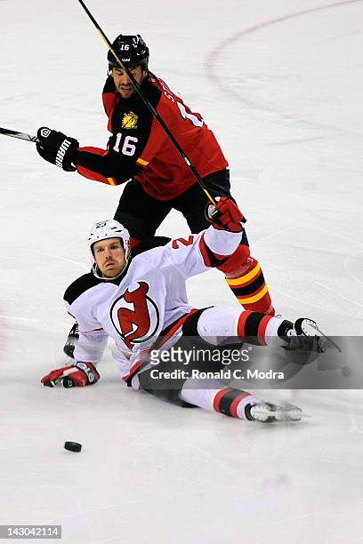 Patrik Elias of the New Jersey Devils hits the ice as Marco Sturm of the Florida Panthers chases during Game Two of the Eastern Conference...