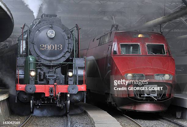 Belgian locomotive from 1940s is parked beside a Thalys train on the tracks of the Gare du Midi in Brussels on April 18, 2012 on the occasion of the...