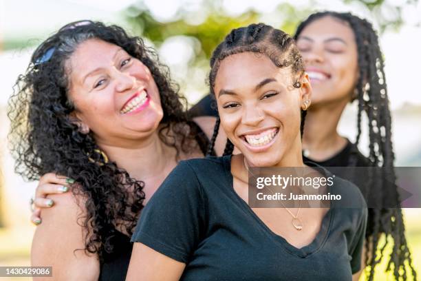 afro-latinx young women posing with their mother - dominican ethnicity stock pictures, royalty-free photos & images