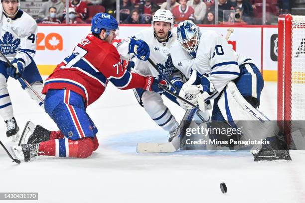 Kirby Dach of the Montreal Canadiens skates into Victor Mete of the Toronto Maple Leafs as goaltender Matt Murray defends his net from the puck...