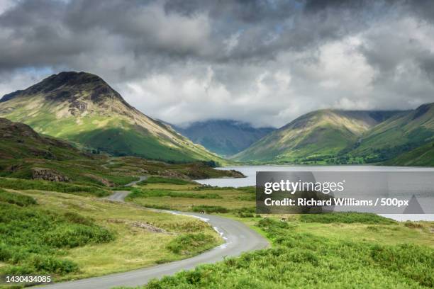 scenic view of road by mountains against sky,wast water,seascale,united kingdom,uk - copeland cumbria stock pictures, royalty-free photos & images