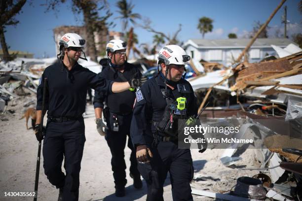 Members of Virginia Task Force 2 Urban Search and Rescue comb through the wreckage on Fort Myers Beach looking for victims of Hurricane Ian October...