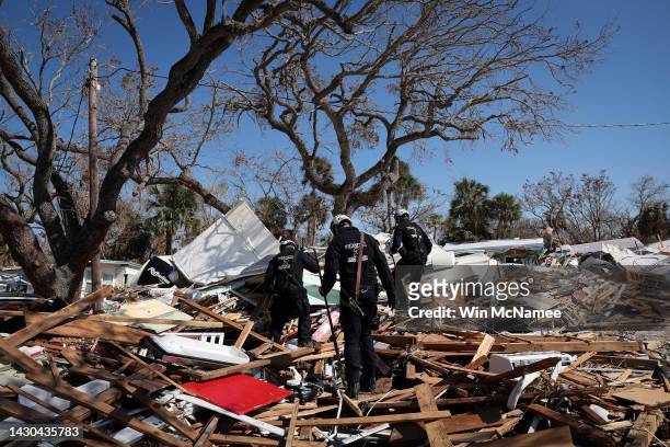 Members of Virginia Task Force 2 Urban Search and Rescue comb through the wreckage on Fort Myers Beach looking for victims of Hurricane Ian October...