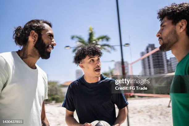 coach talking to athletes during footvolley class - teacher trigger stock pictures, royalty-free photos & images