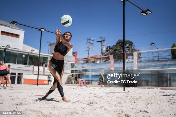 woman playing beach volleyball - candid volleyball stock pictures, royalty-free photos & images