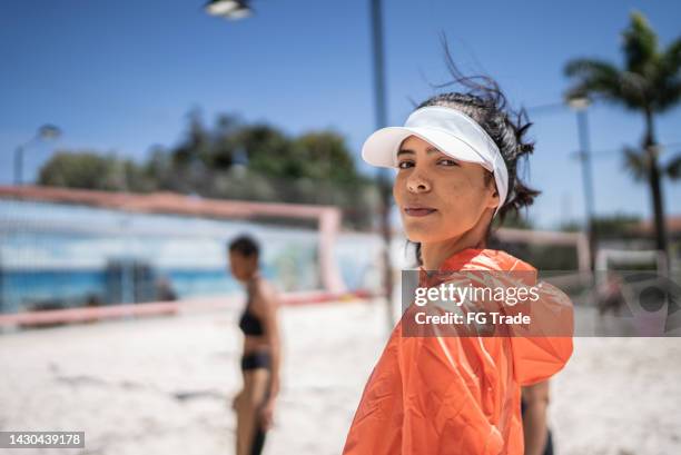 portrait of a young woman in a beach tennis court - girls beach volleyball stock pictures, royalty-free photos & images