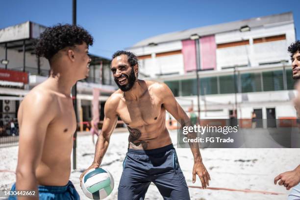 male friendship talking in beach volleyball - beach volleyball team stock pictures, royalty-free photos & images