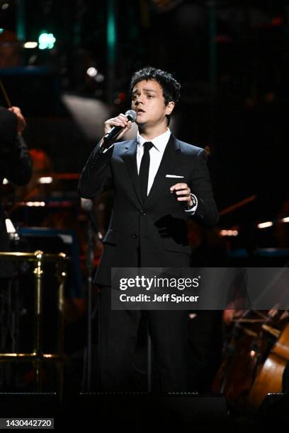 Jamie Cullum performs on stage accompanied by The Royal Philharmonic Concert Orchestra during The Sound of 007 in concert at The Royal Albert Hall on...