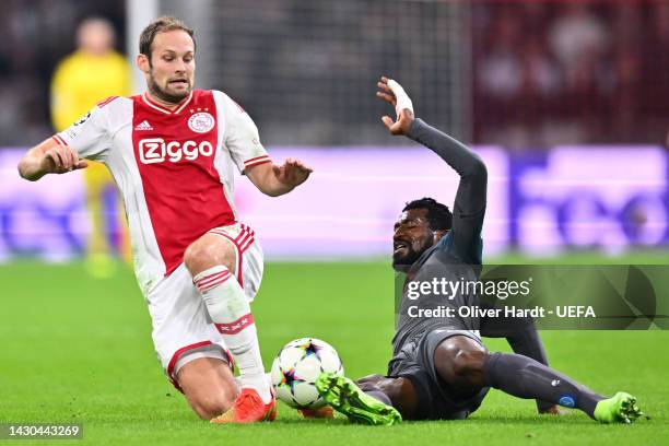 Daley Blind of Ajax battles for possession with Andre-Frank Zambo Anguissa of SSC Napoli during the UEFA Champions League group A match between AFC...