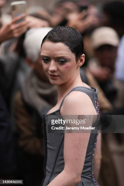 Maisie Williams is seen wearing a grey corsage dress, outside Thom Browne during Paris Fashion Week on October 03, 2022 in Paris, France.