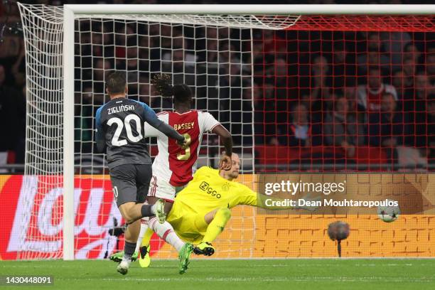 Piotr Zielinski of SSC Napoli scores their team's third goal past Remko Pasveer of Ajax during the UEFA Champions League group A match between AFC...