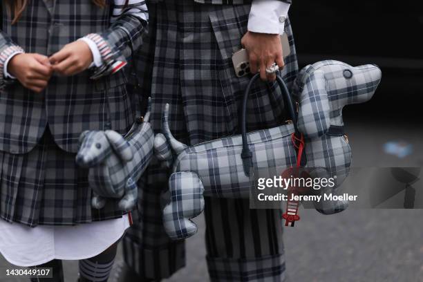 Fashion week guest is seen wearing total Thom Browne matching partner looks, outside Thom Browne during Paris Fashion Week on October 03, 2022 in...