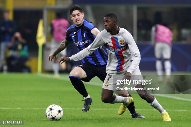 Ousmane Dembele of FC Barcelona is challenged by Alessandro Bastoni of FC Internazionale during the UEFA Champions League group C match between FC...