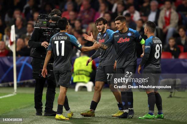 Khvicha Kvaratskhelia of SSC Napoli celebrates with teammates after scoring their team's fifth goal during the UEFA Champions League group A match...
