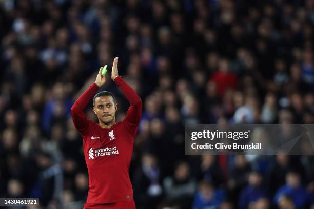 Thiago Alcantara of Liverpool applauds the fans as they are substituted off during the UEFA Champions League group A match between Liverpool FC and...
