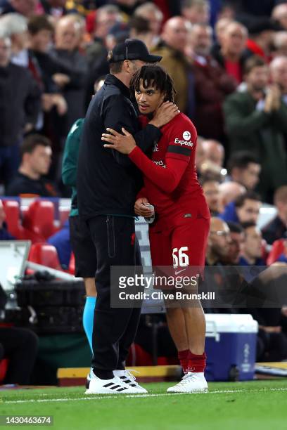 Juergen Klopp embraces Trent Alexander-Arnold of Liverpool after they are substituted off during the UEFA Champions League group A match between...