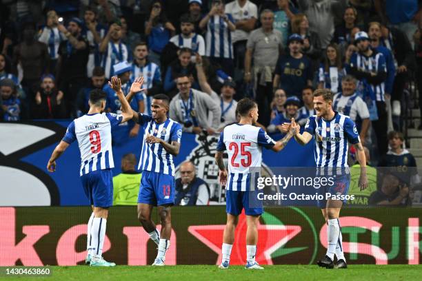 Galeno of FC Porto celebrates with teammate Mehdi Taremi after scoring their team's second goal during the UEFA Champions League group B match...