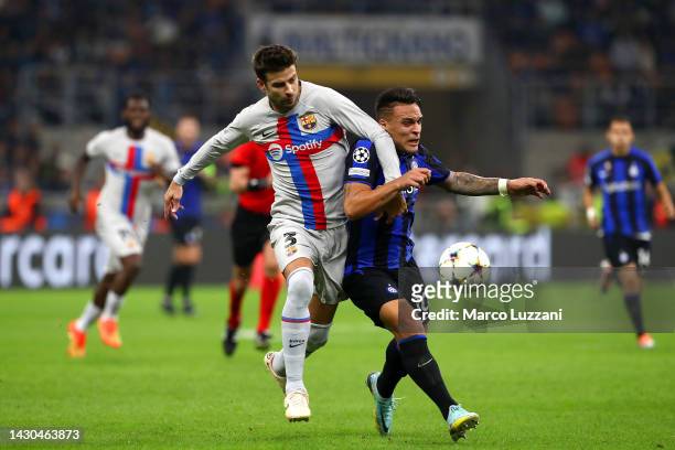 Gerard Pique of FC Barcelona battles for possession with Lautaro Martinez of FC Internazionale during the UEFA Champions League group C match between...
