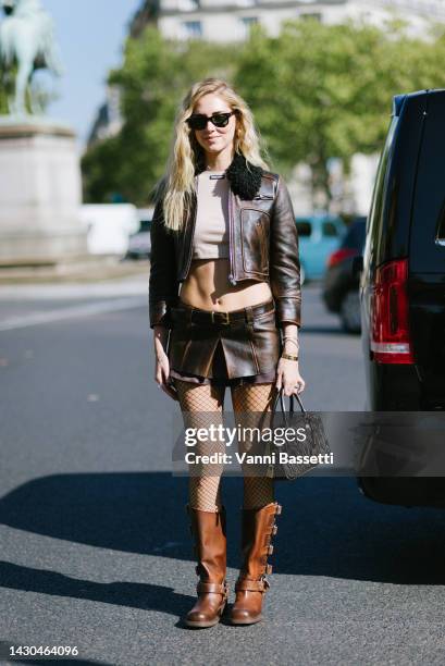 Chiara Ferragni poses wearing a Miu Miu top crop, Miu Miu leather jacket, Miu Miu leather shorts and Miu Miu leather biker boots after the Miu Miu...