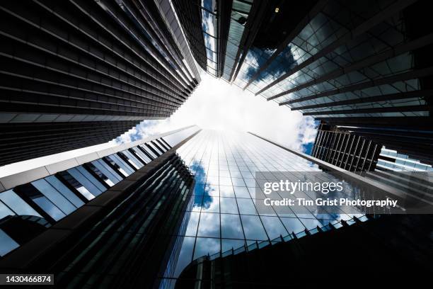 directly below shot of modern office buildings - zusammenschluss stock-fotos und bilder