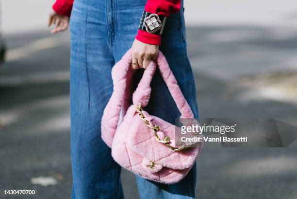 Guest poses with a Chanel pink furry bag after the Chanel show during Paris Fashion Week - Womenswear Spring/Summer 2023 on October 04, 2022 in...