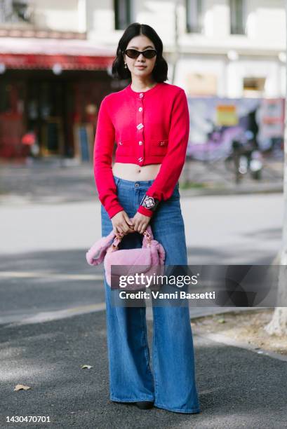 Guest poses with a Chanel pink furry bag after the Chanel show during Paris Fashion Week - Womenswear Spring/Summer 2023 on October 04, 2022 in...