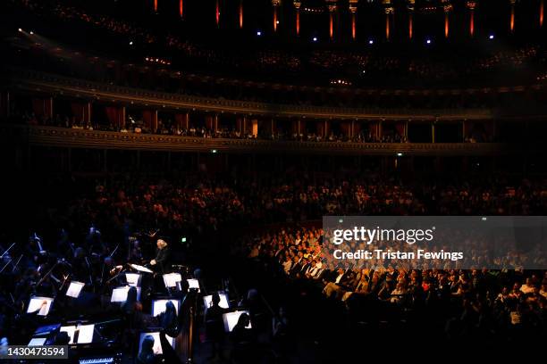 Composer Nicholas Dodd performs on stage accompanied by The Royal Philharmonic Concert Orchestra during The Sound of 007 in concert at The Royal...