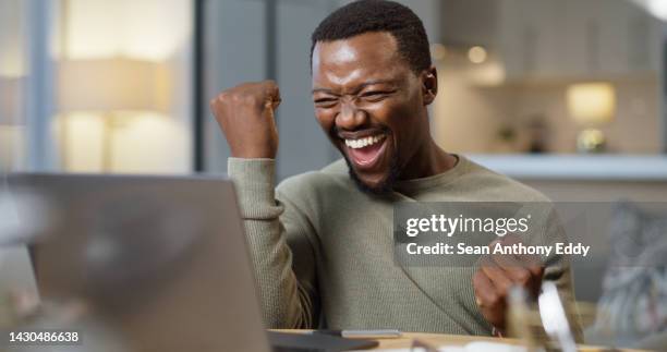 motivation, wow and success with a business man cheering in a celebration while working on a laptop in his home office. winner, deal and yes with a male startup employee celebrating in his house - excited money computer stock pictures, royalty-free photos & images