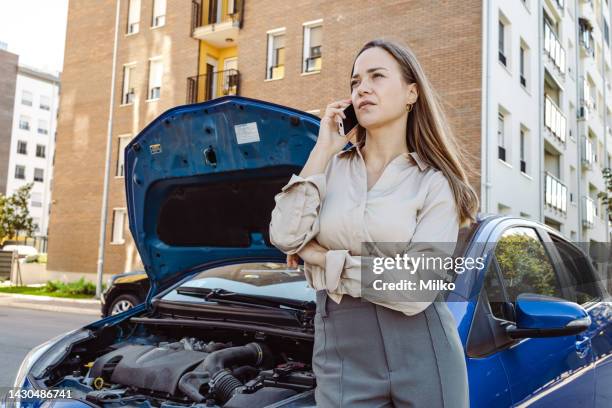 young woman calls the roadside assistance service - bad luck stock pictures, royalty-free photos & images