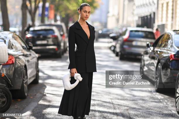 Sarah Lysander is seen wearing an A.W.A.K.E. Mode black jacket and black skirt and A.W.A.K.E. Mode white bag outside the A.W.A.K.E. Mode show during...