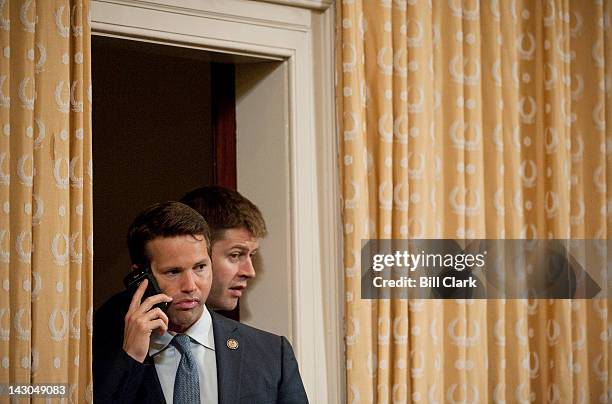 Rep. Aaron Schock, R-Ill., talks onm his cell phone as he waits to vote on an amendment during the House Ways and Means Committee markup of...