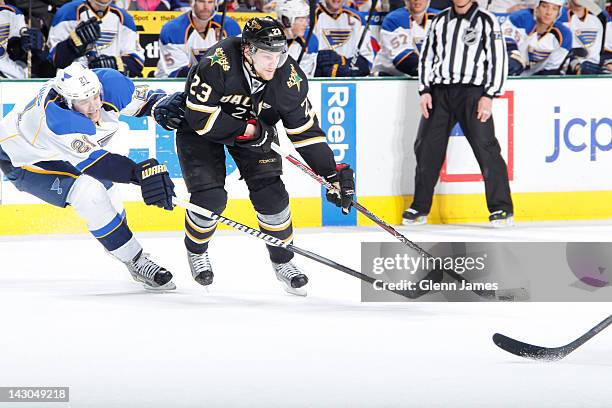 Tom Wandell of the Dallas Stars tries to keep the puck away against Patrik Berglund of the St. Louis Blues at the American Airlines Center on April...
