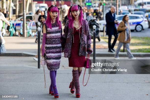 Twins Ami Amiaya & Aya Amiaya wears striped dress, knitted gloves, legwarmers, bags outside Chanel during Paris Fashion Week - Womenswear...