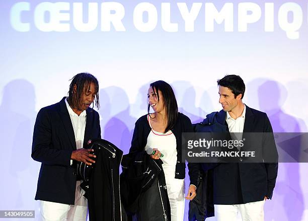 Former French flag bearers Jackson Richardson, Assia El Hannouni and Tony Estanguet pose to present news Olympic sportswear, 100-day countdown to the...