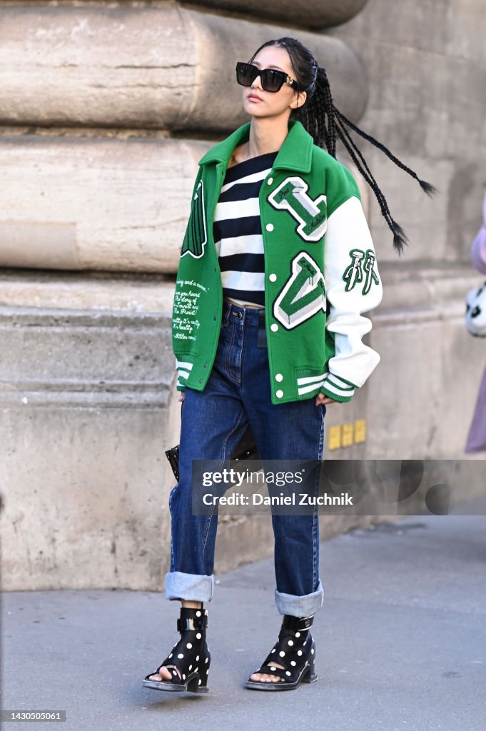 A guest is seen wearing a Louis Vuitton varsity jacket, blue and News  Photo - Getty Images