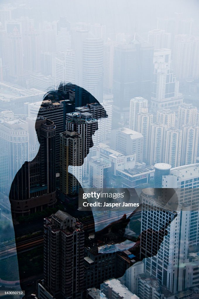 Double exposure of cityscape and man