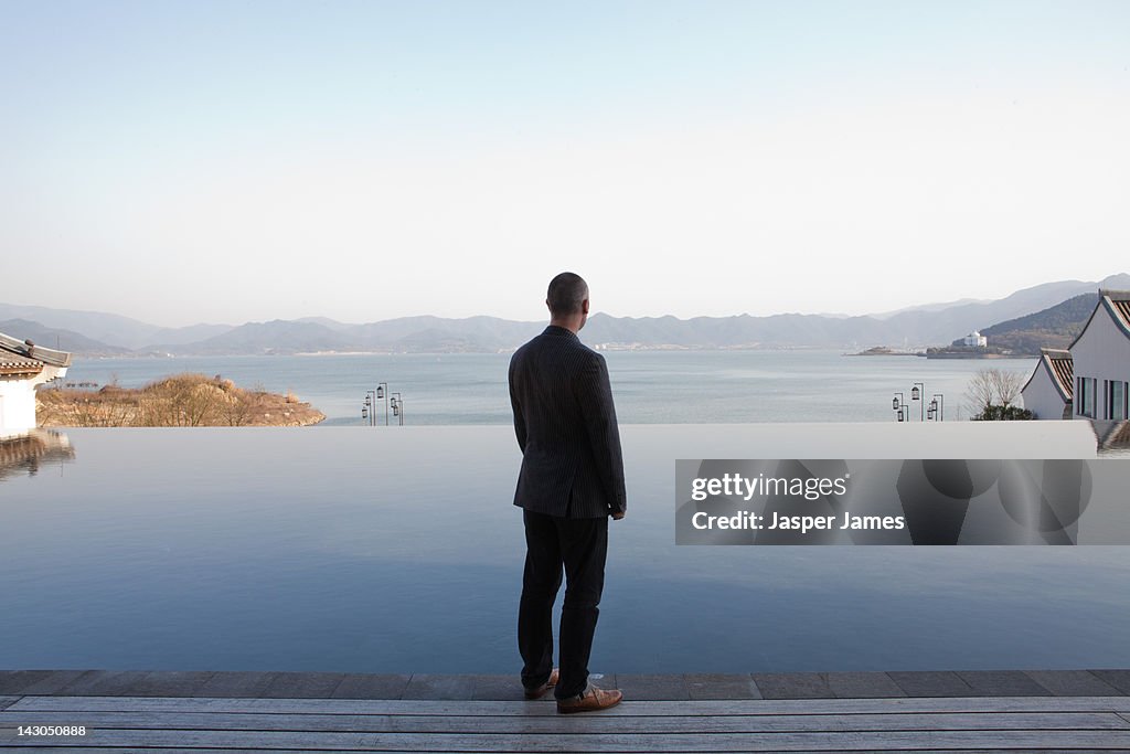 Man looking out to lake in ningbo,china