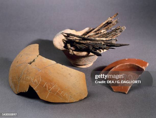 Iron and bronze styles for writing on wax or clay tablets, with examples of the Greek and Gallic alphabet. Objects from Vertillum, France....