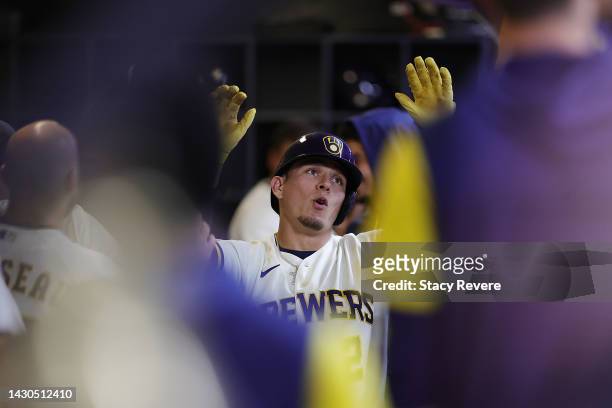 Luis Urias of the Milwaukee Brewers is congratulated by teammates following a home run against the Arizona Diamondbacks during the third inning at...