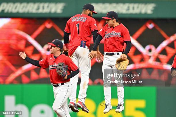 Myles Straw Amed Rosario and Steven Kwan of the Cleveland Guardians celebrate after defeating the Kansas City Royals at Progressive Field on October...