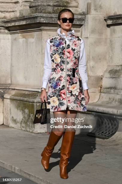 Elizabeth Sulcer is seen wearing a floral Louis Vuitton dress, brown boots and brown Louis Vuitton bag outside the Louis Vuitton show during Paris...