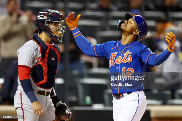 Francisco Lindor of the New York Mets celebrates his solo home run in the first inning as Tres Barrera of the Washington Nationals looks on during...