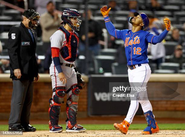 Francisco Lindor of the New York Mets celebrates his solo home run in the first inning as Tres Barrera of the Washington Nationals reacts during game...