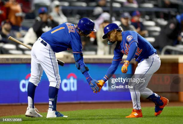 Jeff McNeil of the New York Mets congratulates Francisco Lindor after Lindor hit a solo home run in the first inning against the Washington Nationals...