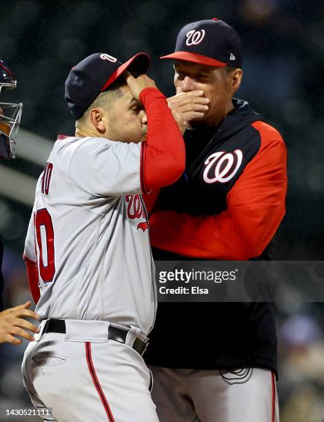 Pitching coach Jim Hickey of the Washington Nationals talks with starting pitcher Paolo Espino in the first inning against the New York Mets during...