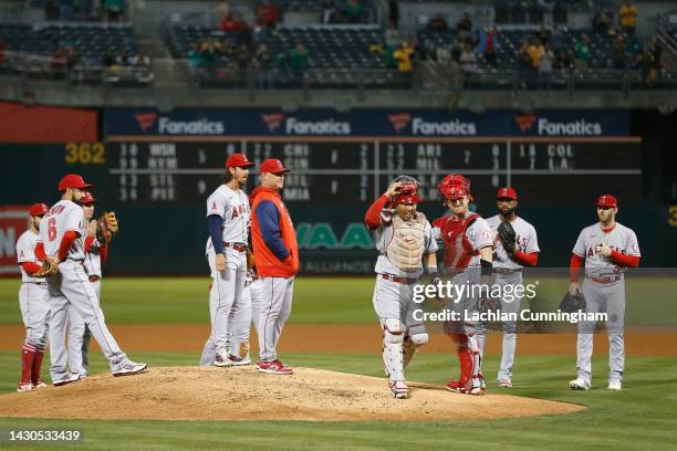 Catcher Kurt Suzuki of the Los Angeles Angels acknowledges the fans as he exits the game after the first pitch in the bottom of the first inning...