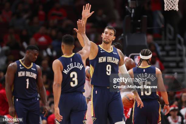 Willy Hernangomez of the New Orleans Pelicans celebrates with CJ McCollum against the Chicago Bulls during the first half of a preseason game at the...