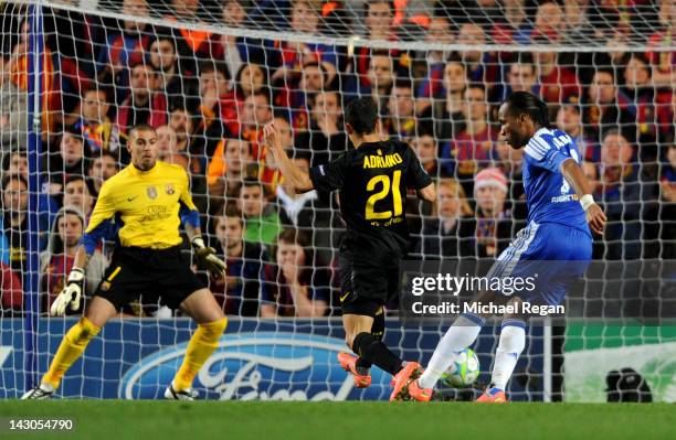 Didier Drogba of Chelsea shoots past Adriano Correia and goalkeeper Victor Valdes of Barcelona to score the opening goal during the UEFA Champions...