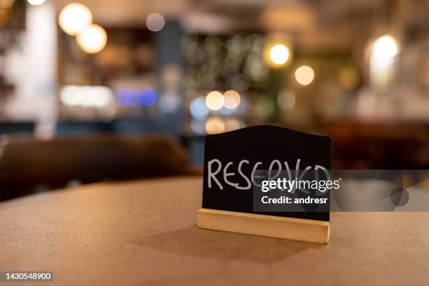 close-up on a reserved sign on a table at a restaurant - making a reservation stock pictures, royalty-free photos & images