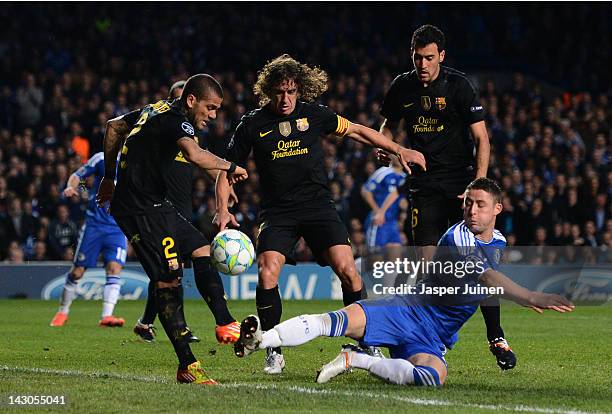 Gary Cahill of Chelsea challenges for the ball with Carles Puyol and Daniel Alves of Barcelona during the UEFA Champions League Semi Final first leg...